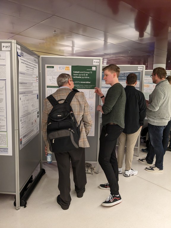 Leo sharing his science with a visitor at his poster